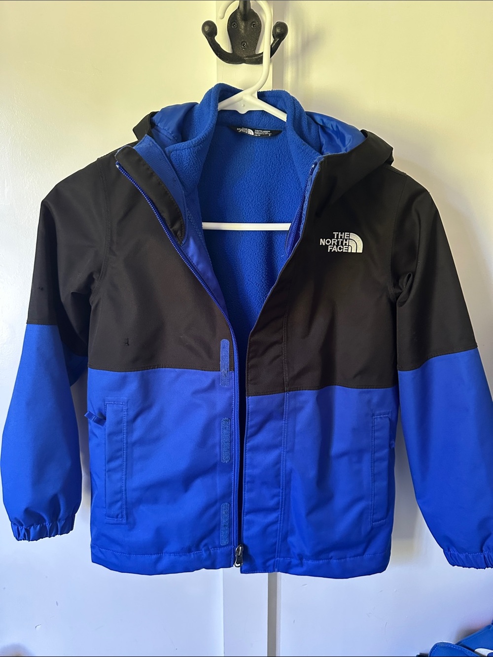 The North Face Kids Blue and Black Hooded Jacket with zip out fleece.